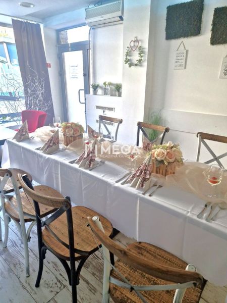 Stylish gastro spaces with wood-decor flooring and a decorated table for celebrations.