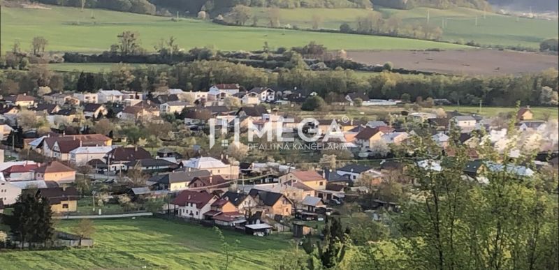 An aerial view of the village Lackovce surrounded by agricultural and forest lands.