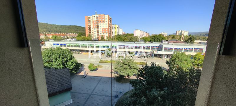 The view from a 3-room apartment in Humenné of the surrounding buildings and greenery.
