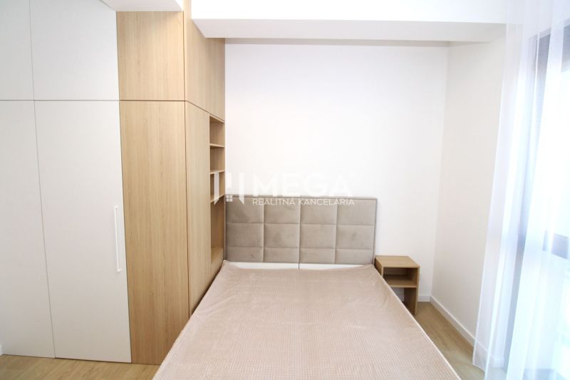 Bedroom in a 3-room apartment with a bed, built-in wardrobe, and wooden decor flooring.