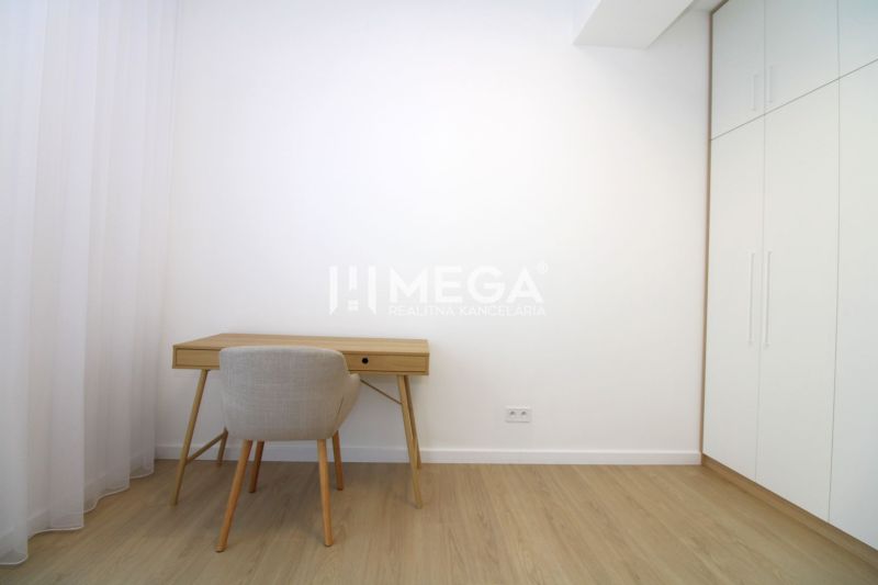 A workspace in a 3-room apartment with a wooden decor floor and white furniture.