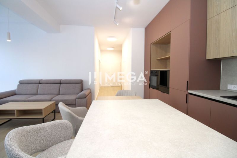 Living area of a 3-room apartment with a comfortable sofa, dining table, and modern kitchen.