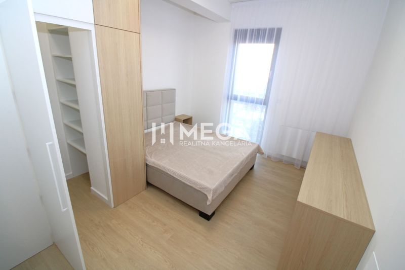 Bedroom in a 3-room apartment with wood-patterned flooring and storage space.