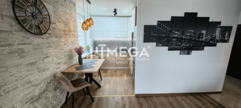 A wall with decorative stone and a kitchen with a wooden decor floor in a 3-room apartment.