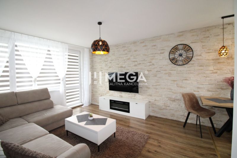 Living room with a light sofa and wood-patterned flooring in a 3-room apartment.