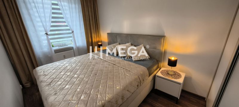 A bedroom in a 3-room apartment with a bed, nightstands, and a floor with a wood decor.