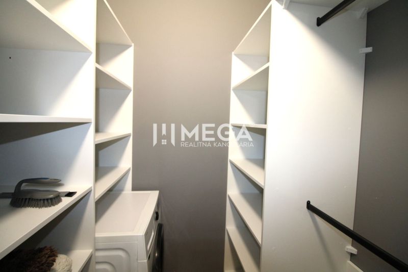 A wardrobe in a 3-room apartment with shelves and a washing machine.