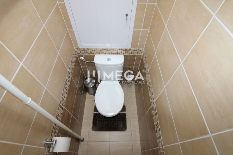 A toilet with tiles in a 3-room apartment, coordinated tile colors.