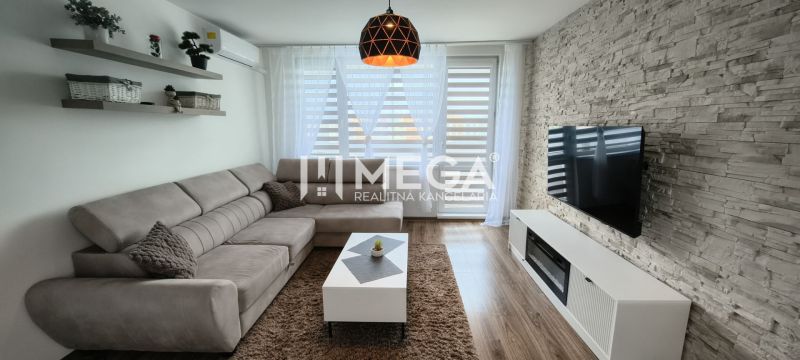 Living room in a 3-room apartment with a corner sofa and a wooden decor floor.