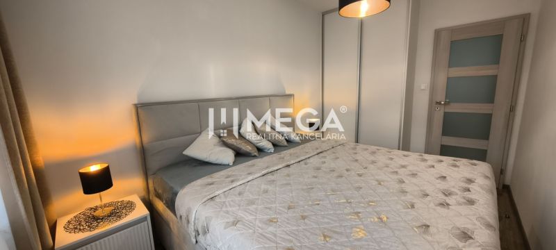 A bedroom in a 3-room apartment with a comfortable bed and a lamp on the nightstand.