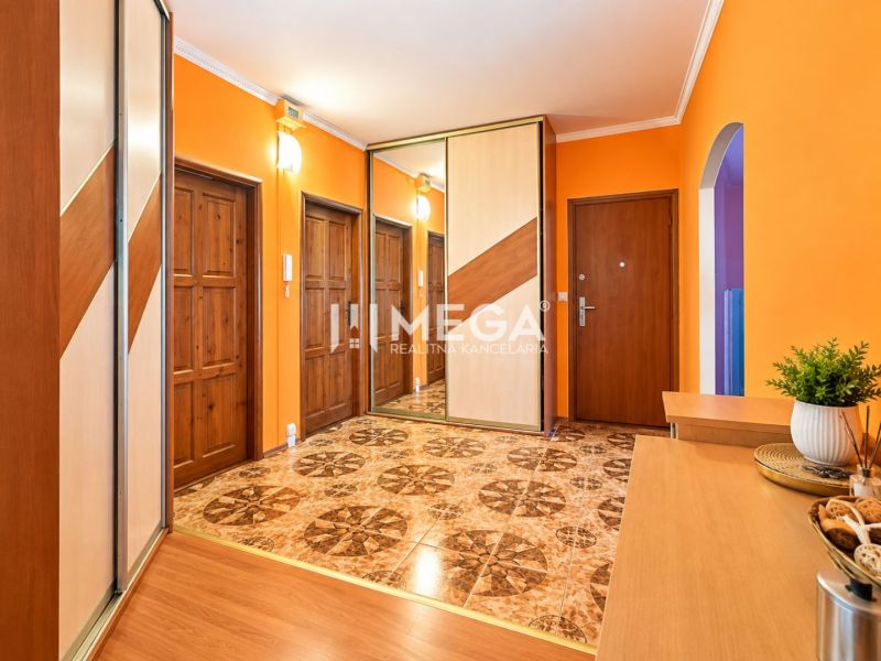 Entrance hall in a 4-room apartment with colorful walls and a wardrobe.