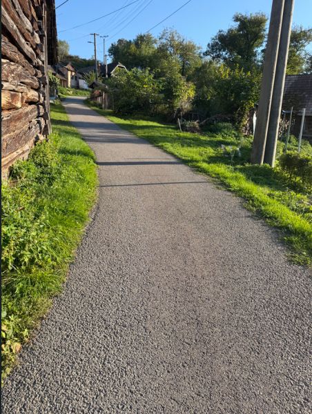 The road between houses in Košecké Podhradie with plots for housing.