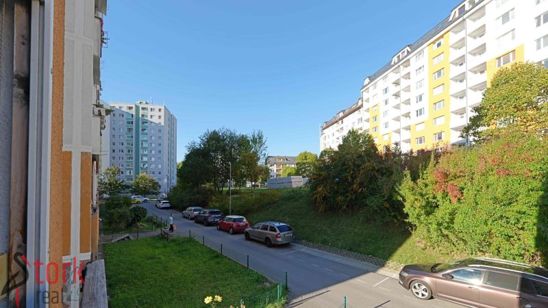 Rozkvet Street, Považská Bystrica, with apartment buildings and parked cars near a 3-room apartment.