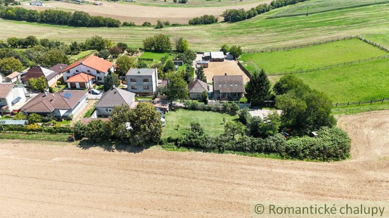 Village gardens in Pastuchov with houses surrounded by fields and meadows.