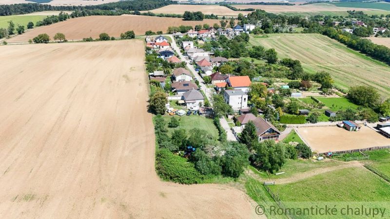 An aerial photograph captures the view of a village near a field in Záhrady, Pastuchov.