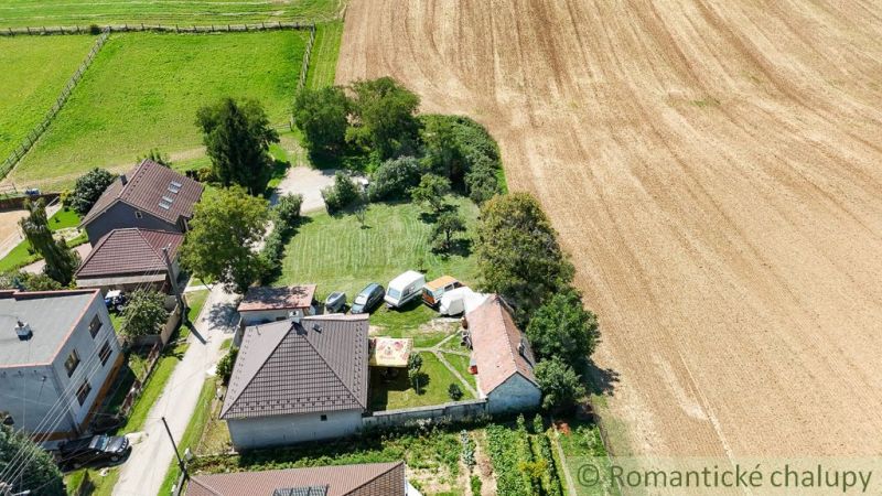 In Pastuchov, there are gardens surrounded by fields and village houses.