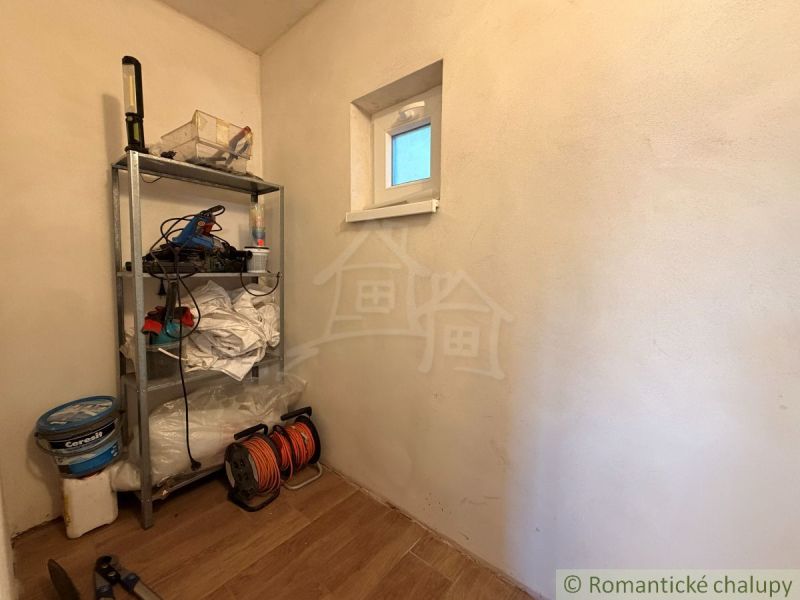 Storage rack with tools and floor with wooden decor in the cottage.
