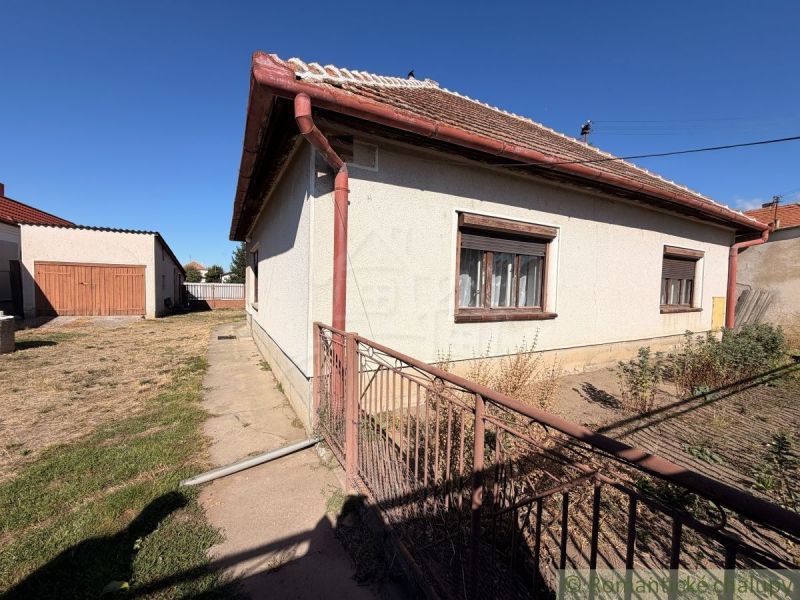 A family house in Hurbanovo with a large fenced garden, an adjacent garage, and a grassy plot.