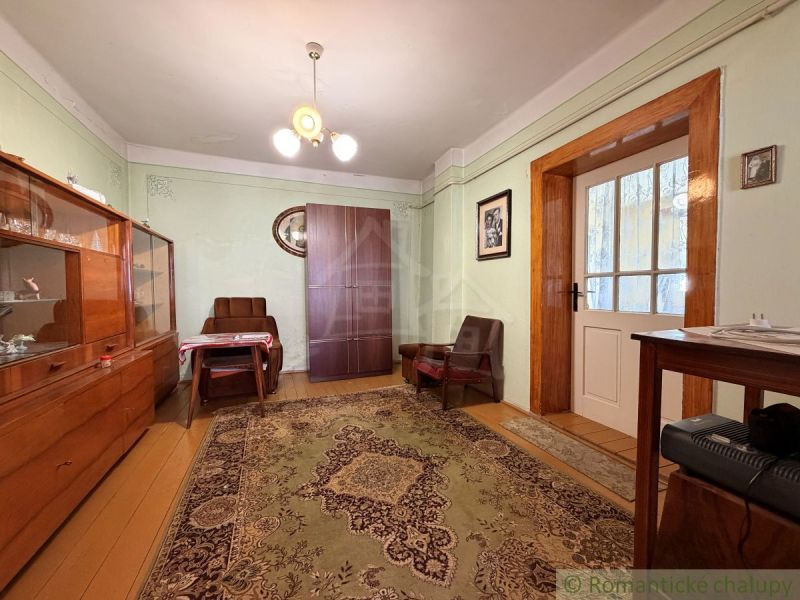 Living room in a family house with wooden furniture and a textile carpet.