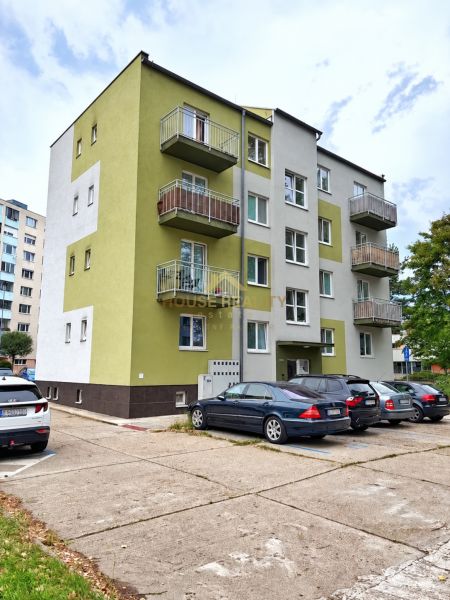 Apartment building on Andrusovova Street, Bratislava - Petržalka with parked cars in front of the building.