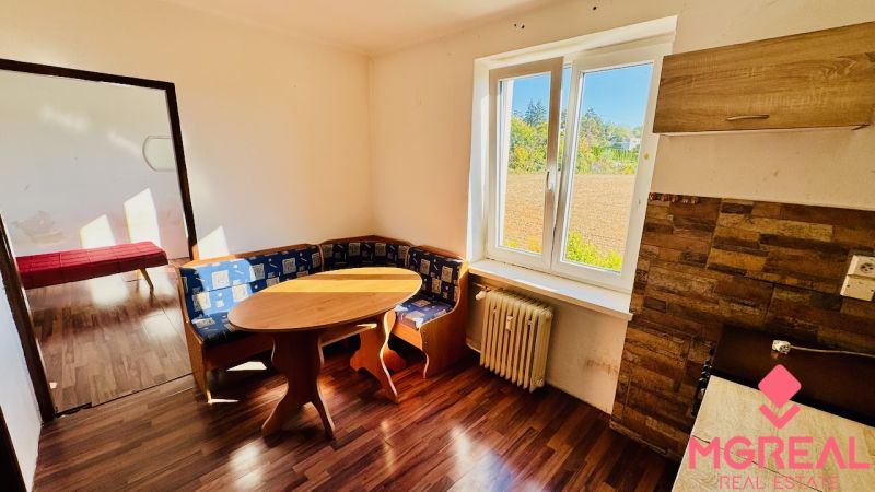 1-bedroom apartment with a corner sofa and flooring with a wood design.