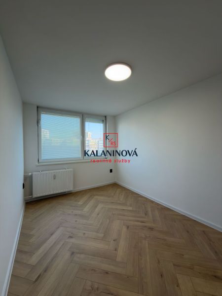 A bright room in a 4-room apartment with a wooden decor floor.