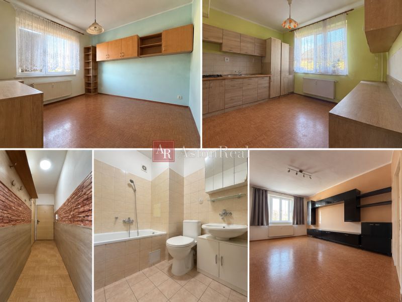 Interior of a 2-room apartment with a wooden decor floor and a light kitchen.