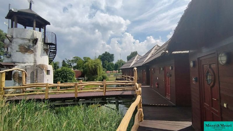 A cottage by the Senec lakes with wooden elements and a tower-like structure in the garden.