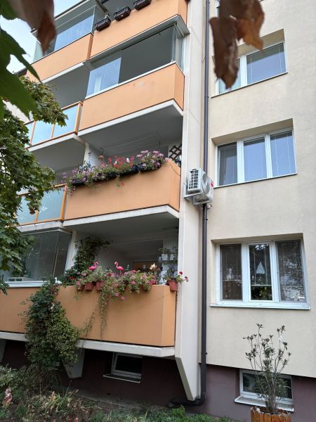An apartment building with balconies full of flowers on Za hradbami Street in Pezinok.