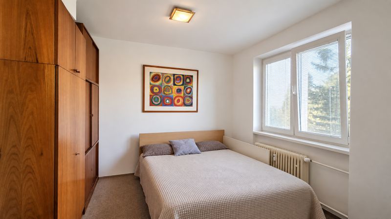 Bedroom with a double bed and a built-in wardrobe in a 3-room apartment.