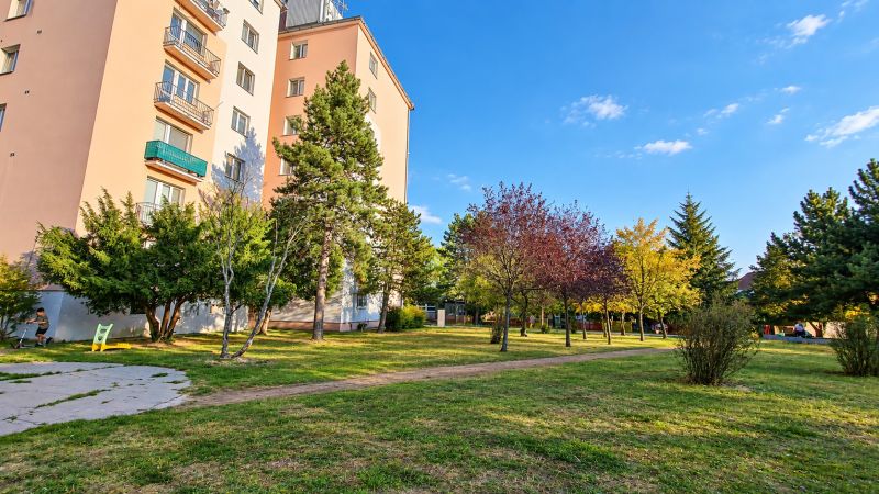 A panel house surrounded by greenery on Za hradbami Street, Pezinok, suitable for a 3-room apartment.