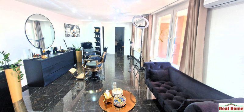 Commercial space with black furniture, an armchair, and decorative elements, floor with a dark decor.