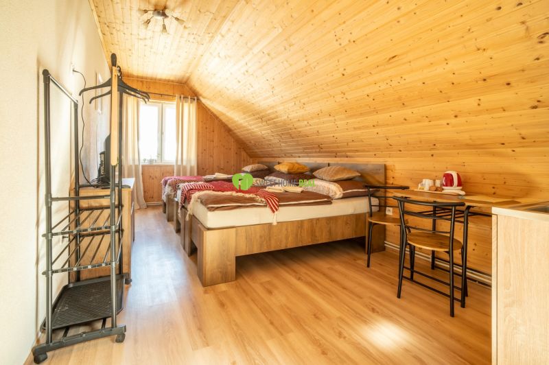 A room with wooden paneling, a floor with a wooden decor, hotels and guesthouses.