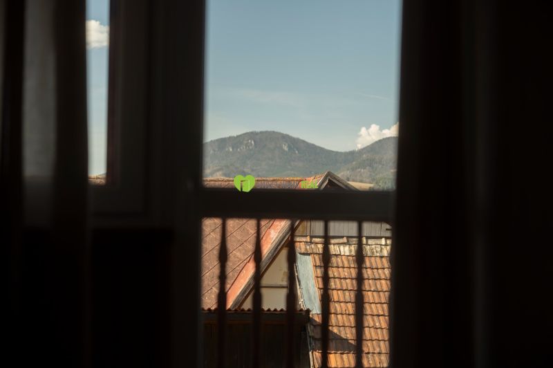 View from the window of rooftops and mountains in Liptovský Michal, hotels and guesthouses.