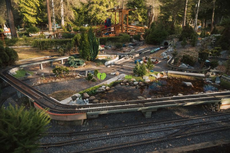 In the area near Liptovský Michal, there is a model railway surrounded by greenery.