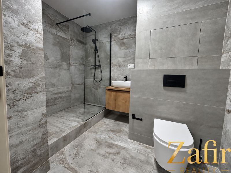 Bathroom in a 3-room apartment with a modern shower and elegant tiles.