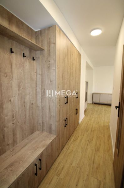 A hallway with a built-in wardrobe and a wooden decor floor in a 2-room apartment.