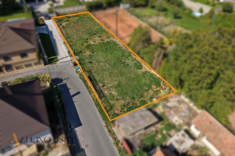 A plot for residential use in Dunajská Streda in Malý Blahovo, bordered by a road and greenery.