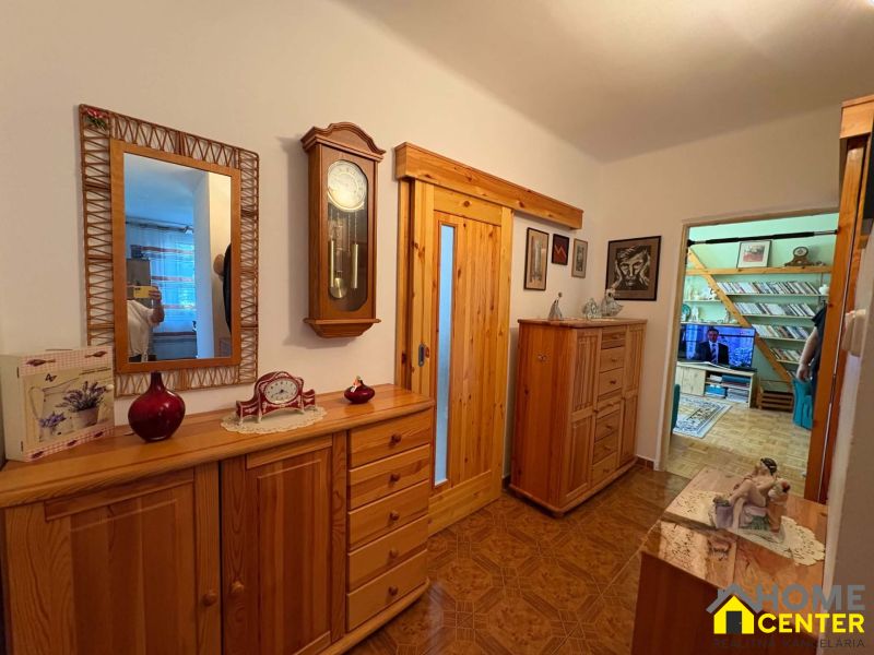 The entrance hall of a 3-room apartment with wooden decor and classic furniture.