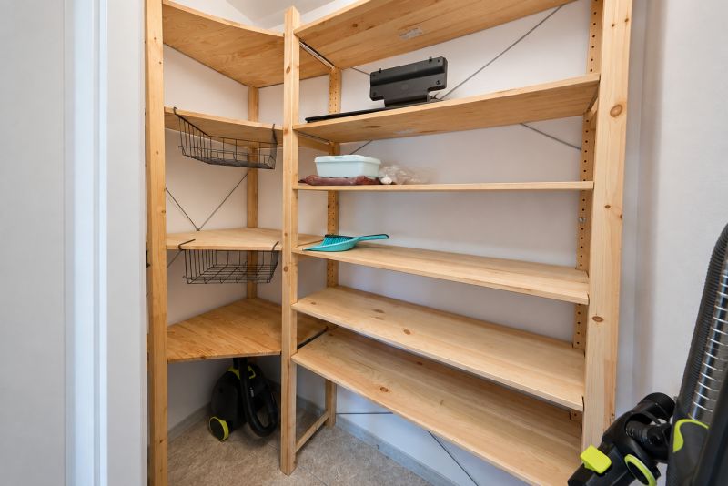 Storage space with shelves and a vacuum cleaner in a 2-room apartment.