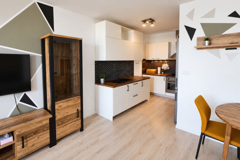 A kitchen in a 2-room apartment with geometric patterns and a wooden decor floor.