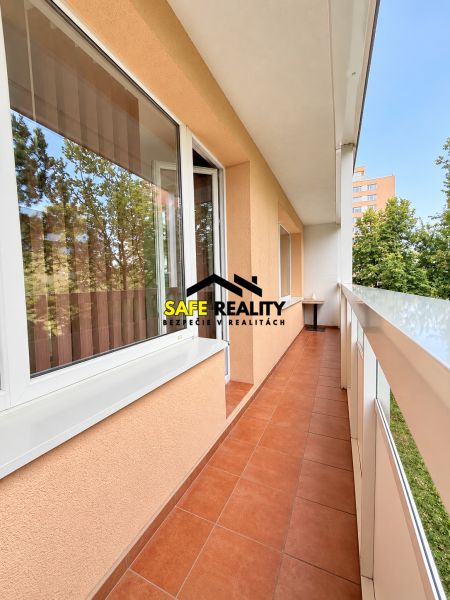 A balcony at a one-room apartment on Bajzova Street in Žilina, with ceramic tiles and a view.