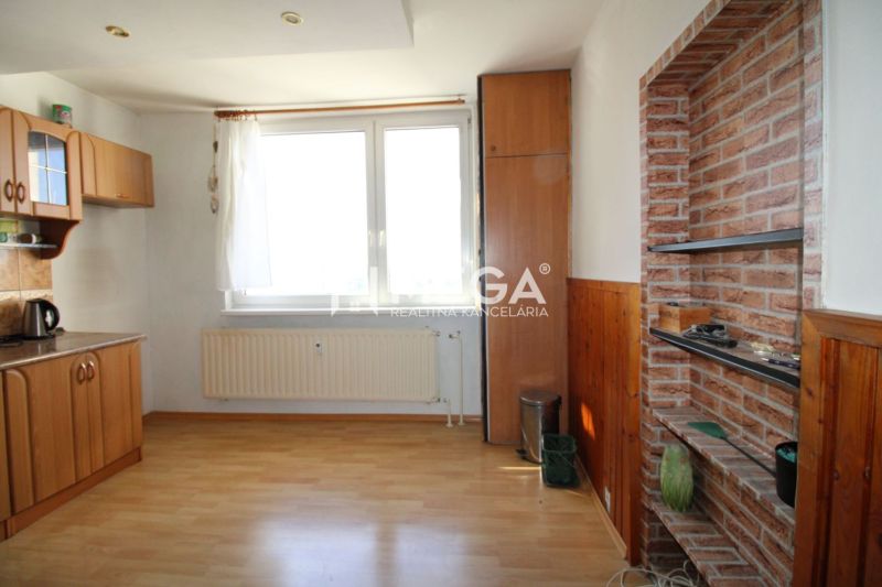 A kitchen with a wood-patterned floor in a 3-room apartment with built-in cabinets.