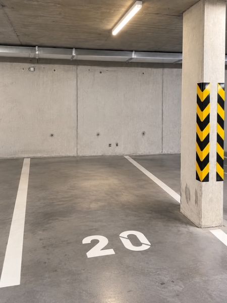 Underground garage with a concrete floor and parking space number 20.