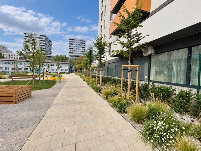 A building with surrounding greenery at Muchovo námestie in Bratislava, near a 2-room apartment.
