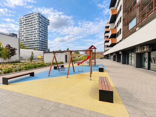 Playground with benches at Muchovo Square in Bratislava, in front of a 2-room apartment.