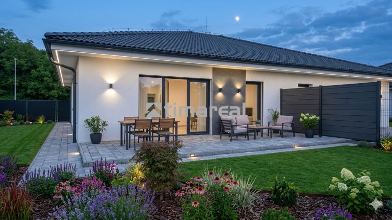 A family house in Hôrka nad Váhom with a terrace, lighting, and a garden during the evening.