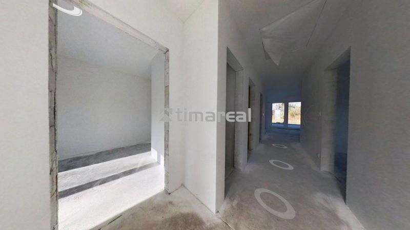 Hallway with white walls and windows in a family house.
