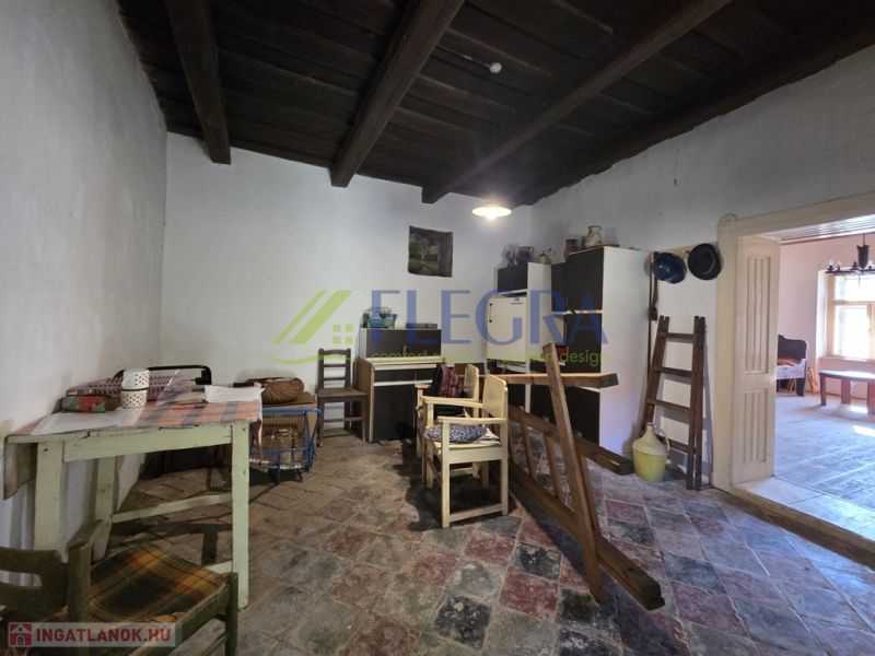 A family house with a rustic interior, wooden ceiling, and colorful tiles.
