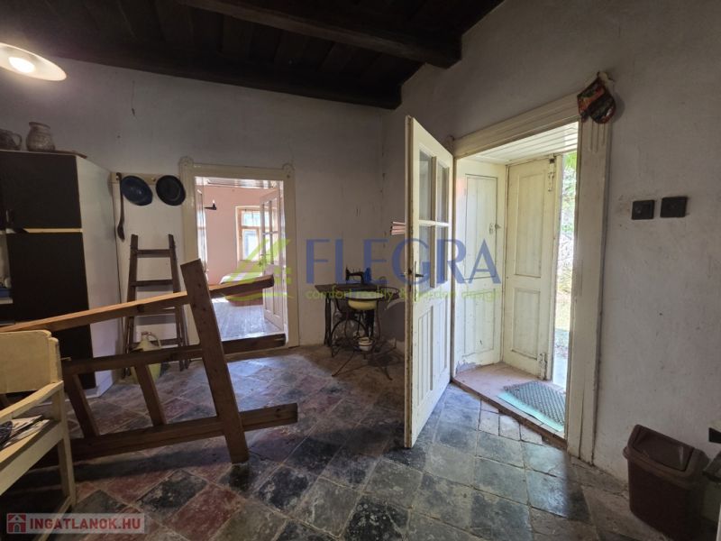The interior of a family house with a tiled floor and wooden furniture.